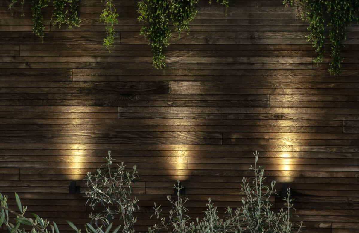 Outdoor lighting reflecting in a shallow pool at dusk